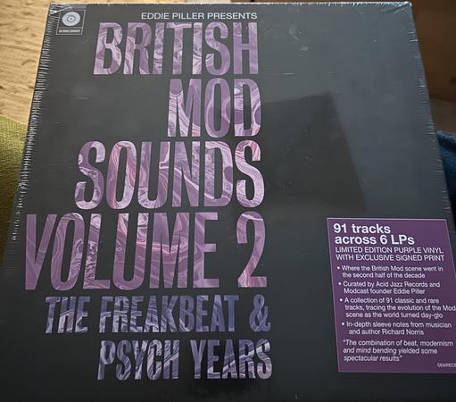 A vinyl record collection titled "British Mod Sounds Volume 2," featuring 91 tracks across 6 LPs, limited edition purple vinyl with an exclusive signed print.