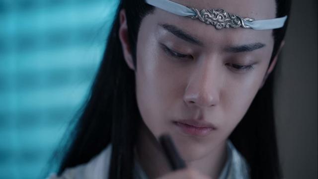 Close in shot of Lan Wangji, focused on his work with Wei Wuxian's makeshift dizi, the flute being just out of frame below the edge of the image but the top of the tool being used to tune the dizi as well as bit of the hand holding the flute just being visible.