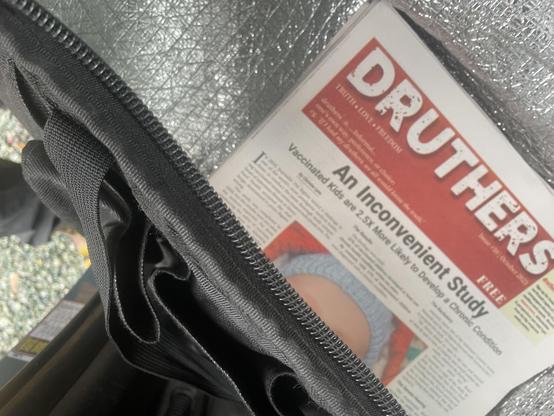 a small stack of druthers newspapers with a bunch of nonsense about vaccinations sits in my bag