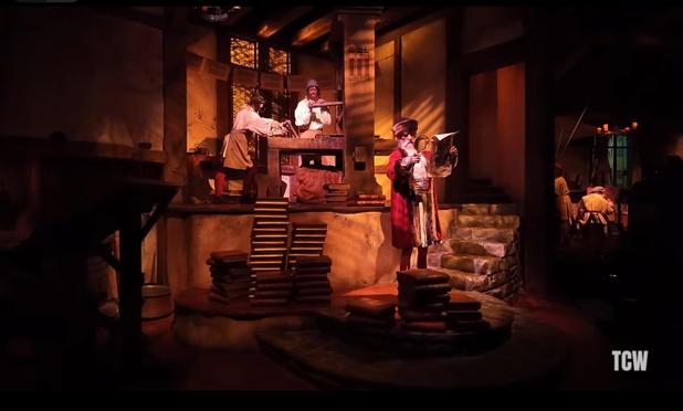 Scene of animatronic figures in a vignette representing Gutenberg’s printing house.