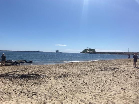 Looking along Horseshoe Beach towards Nobbys just before all the kayak training started. Sunny blue sky day.