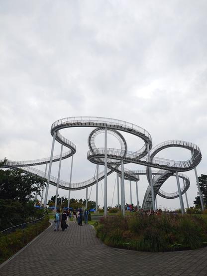 The space walk from the ground. A metallic looping structure with steps for climbing.