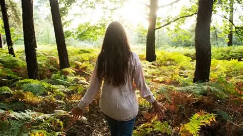 photo of a woman walking in the forest