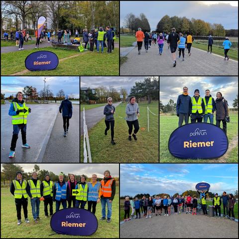 Collage of 7 photos taken at different times during the 236th parkrun at Riemer Park.

1- At the meeting point, around 20 people chat in small groups while waiting for the parkrun to start. Some are wearing yellow volunteer vests. The blue Riemer parkrun sign is placed on the grass in the foreground, while behind it you can see the multicoloured white, yellow and purple banner saying ‘parkrun’. 

2- Runners set off along the park path, starting the first kilometre of the 5 kilometres that make up the parkrun. They are photographed from behind. 

3- Our marshal is at her post by the lake, wearing a hat and a yellow volunteer vest over her anorak. She is holding a yellow sign with a black arrow pointing to her left. A walker can be seen from behind on the right of the photo. In the background, we can see trees in autumn colours and a glimpse of the lake.

4- Two runners cross the finish line, smiling. 

5- A group of four people (visitors from Augsburg) pose behind the blue ‘Riemer parkrun’ sign placed on the grass. There is one woman and three men, two of whom are wearing yellow volunteer jackets. 

6- Eight parkrun volunteers pose together behind the blue riemer parkrun sign. Four are wearing yellow jackets, the Run Director is wearing a dark blue jacket, the parkwalker is wearing a light blue jacket and the tail walker is wearing an orange jacket. They are all smiling.

7- At the starting line, a group of runners and walkers pose while waiting for the parkrun to start. The R