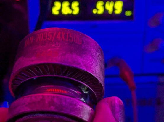 a 4x150d tube glowing. visible in the background are the meters of the power supply showing 26.5 volts, .549 amp.