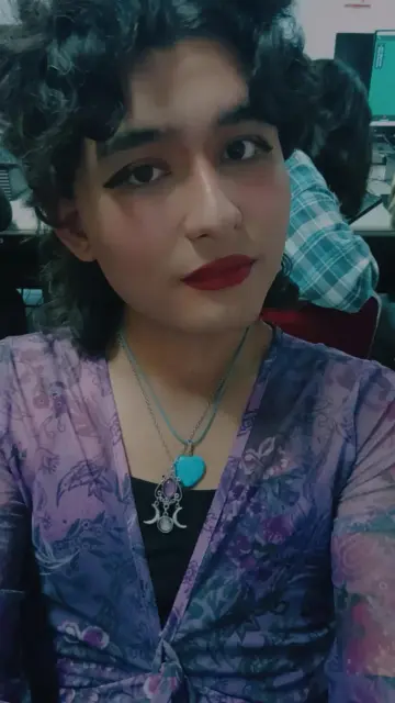 A selfie wearing a whimsy purple blouse.