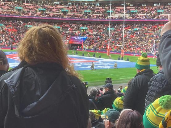 A view of the #Wembley pitch pre-match, with numerous green and gold beanie hats in the image.