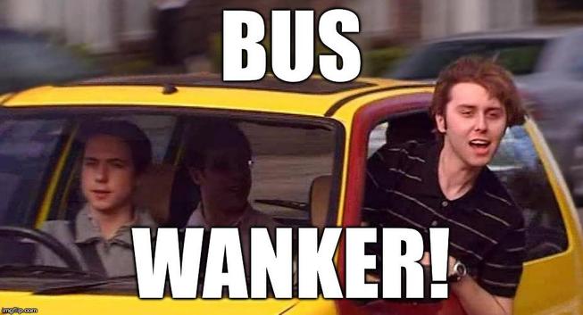 Scene from the Inbetweeners, young man leaning out of the passenger side window of a yellow hatchback car with the words "Bus Wanker!" superimposed on the image in bold white capitals