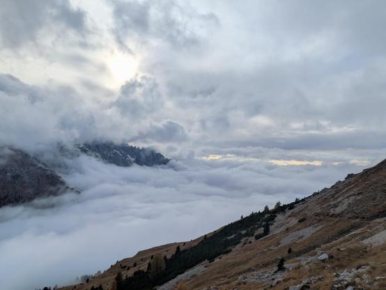 Clouds with some parts of mountain visible, the sun casting a unique light