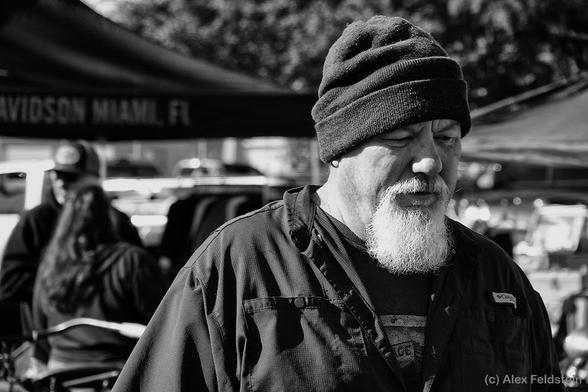 B&W street shot of a guy with a beard and a wool cap