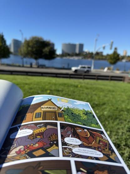 A photograph of lake merritt in the background with a lumberjanes comic in the foreground.