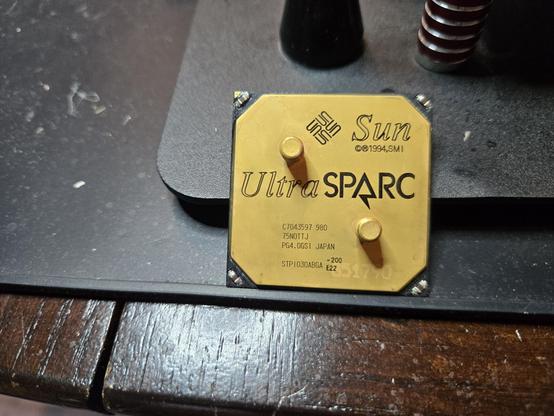 an UltraSPARC chip all cleaned up and looking shiny. it's propped up against the edge of a metal plate to dry.