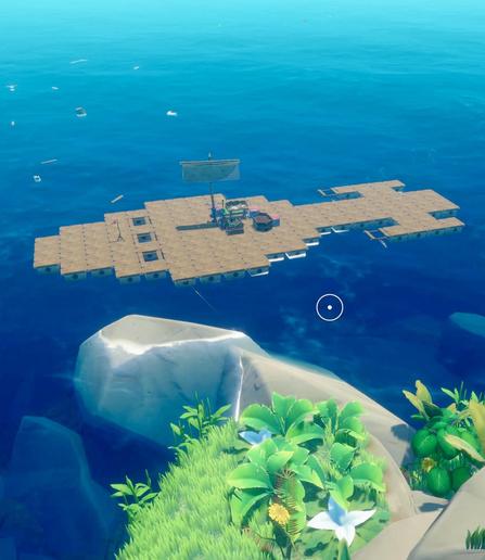 An aerial view of a wooden raft shaped like ship from Star Trek floating on clear blue water. The raft features a small sail, a table, and some storage boxes. In the foreground, there is a rocky shore with lush green vegetation and various plants, including flowers.