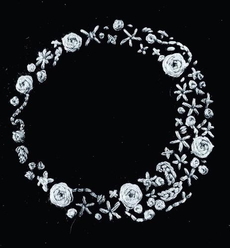 A delicate circular design featuring intricately embroidered silvery white flowers and leaves, displayed on a black background.