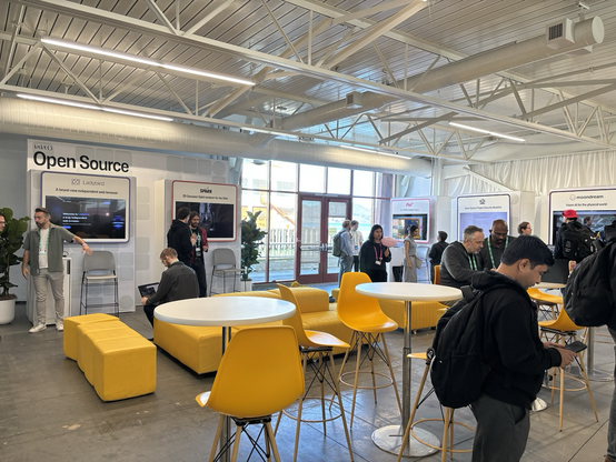 An area about 200 feet by 50 feet, with five small booths around the outside and tables and chairs in the middle