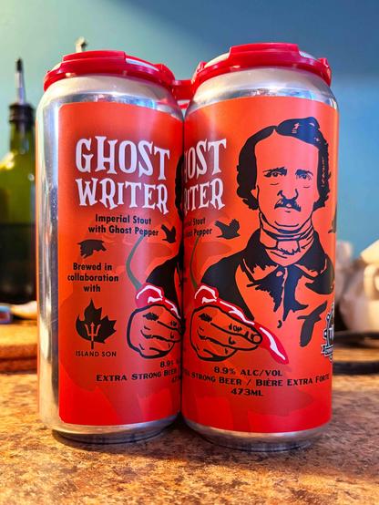 A four-pack of TWB Cooperative Brewing's Ghost Writer Imperial Stout (a collab between TWB and Island Son Hot Sauce). The label is orange, black, white, and red and has "Ghost Writer" in spooky lettering and an image of Edgar Allan Poe holding a chilli pepper as a quill.
