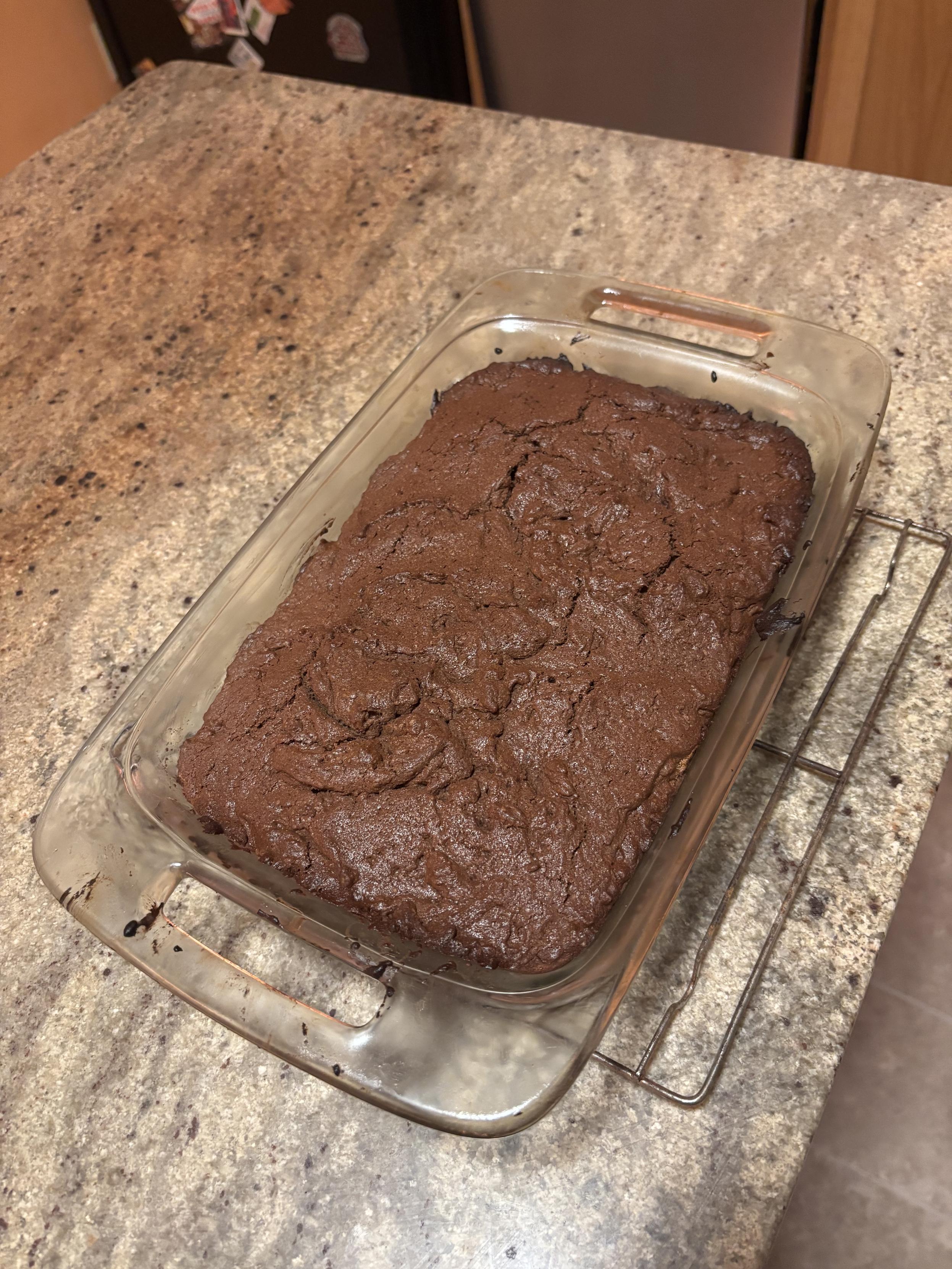 a pan of brownies cooling on a eack on a countertop