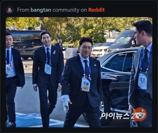 BTS member Kim Namjoon arrives at the APEC summit (second from left) walking behind HYBE Chairman Bang PD who has a bandage/cast on his right hand
