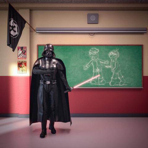 A person dressed as the fictional character Darth Vader from Star Wars is standing in what appears to be a classroom. He is holding a red lightsaber that is turned on. Behind him is a green chalkboard with a simple chalk drawing of two cartoon-style figures; one appears to be pointing something like a lightsaber toward the other. The walls are painted yellow on the top half and red on the bottom half.

On the left side of the wall, there are posters featuring designs associated with the Galactic Empire. Above them, an Imperial symbol flag is hanging from a pole. The floor is light-colored and smooth, and the room has a ceiling with standard acoustic tiles. The overall setting looks like a playful scene mixing classroom elements with Star Wars imagery.