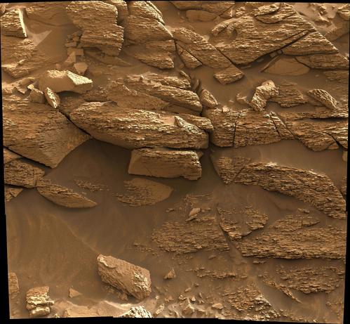 This mosaic was assembled from overlapping mast camera images acquired by Curiosity rover, it provides a close-up of eroded Martian rock formations, showcasing uneven, layered surfaces with reddish-brown tones and scattered fragments that have tumbled from the ridge.