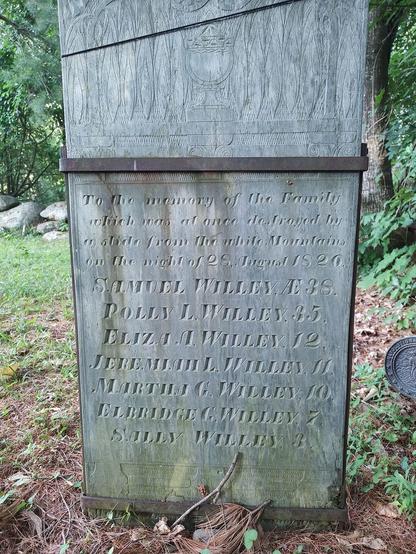 An old tombstone held up by iron supports