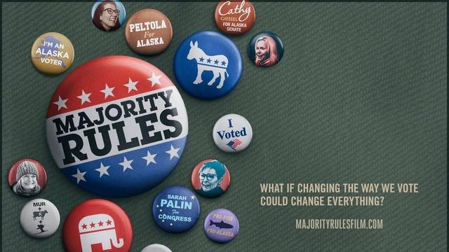 A film poster for documentary film "Majority Rules" shows a collection of political pins scattered across a green cloth. The largest central button says "Majority Rules" in a red, white and blue design. In the bottom right, text says: "What if the Way We Vote Could Change Everything? MajorityRulesFilm.com".