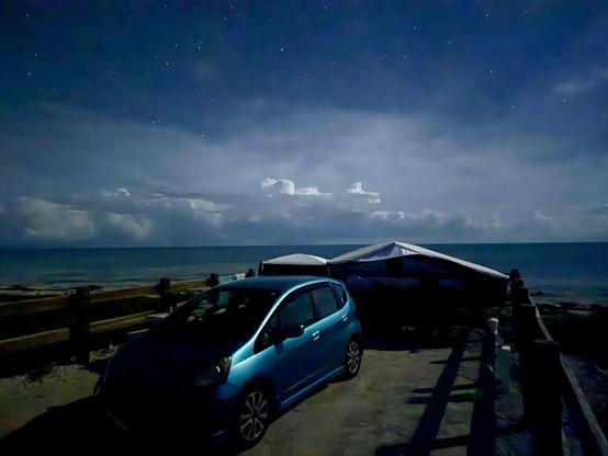 Night shot: cumulus and stars over the Atlantic; tent and Bahia Honda Fit in foreground.