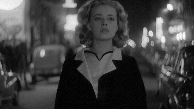 A young Jeanne Moreau walking the city streets at night in glowing, black and white cinematography for Louis Malle's Ascenseur pour l’échafaud