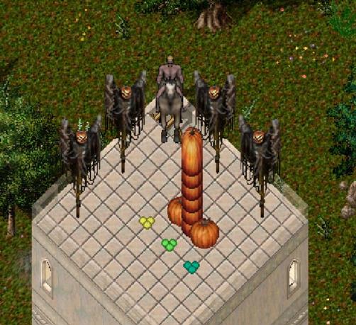 A man stands with his pumpkin scarecrows as they worship the mighty pumpkin tower.