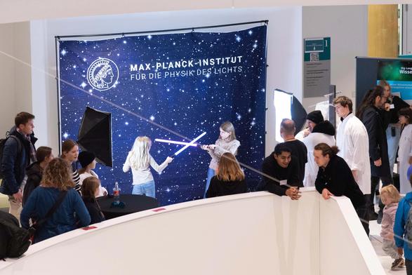 Girls with light sabors taking pictures in our photobox at MPL.