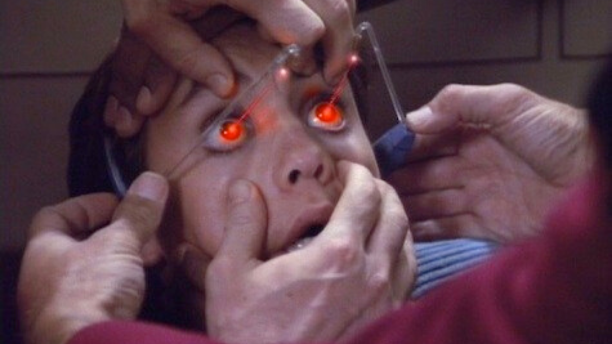 Wesley Crusher's eyes being held open as the bridge crew from the Starship Enterprise places a visual game device on his head and the game projects red light into his eyes. From the Star Trek: The Next Generation season six episode "The Game".