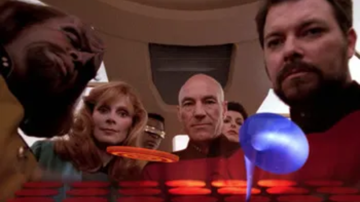 Wesley Crusher's augmented reality field of view through the game device, showing the bridge crew from the Starship Enterprise above a virtual game space with moving game shapes. From the Star Trek: The Next Generation season six episode "The Game".