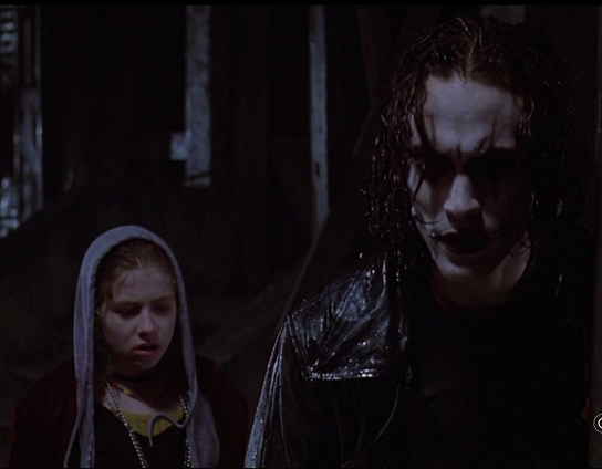 A snap of "The Crow" (1994) where character Sarah is talking with Eric in the rain, not knowing who he is. "What, are you supposed to be a clown or something?"  "...Sometimes..."