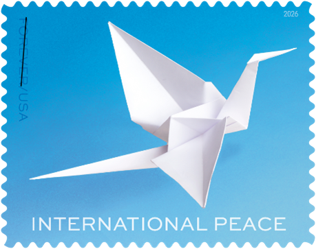 A white origami crane on a blue background. INTERNATIONAL PEACE is written at the bottom