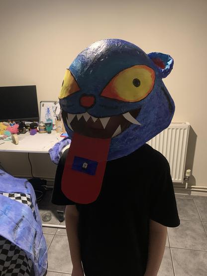 A boy wearing a blue tiger mask