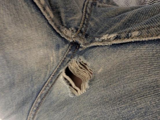 A wear-through hole and thinned denim at the crotch of my Levi's jeans.