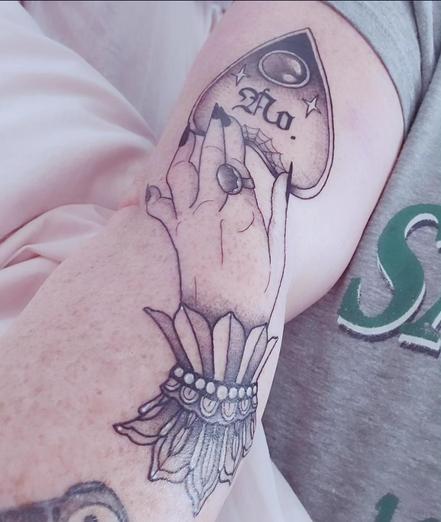 My new tattoo. It's a hand on a ouija board planchette, the planchette says "no."