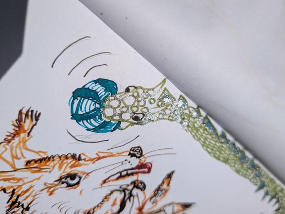 We can see one and a half heads craving the ball, while the shine on the ink is showing up silver.