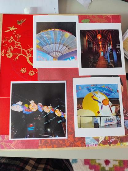 Red background scrapbook because this is the Chinatown lantern festival page.
The top left photo is the fan on top of the central shopping centre, lit up in blue and yellow. Top right is a walkway with hanging red lanterns at night. Bottom left is a light display hanging above a road at night, with plastic lanterns in cloud, mooncake, and rabbit shapes. The last photo is a big white rabbit sitting on a white rabbit sweet