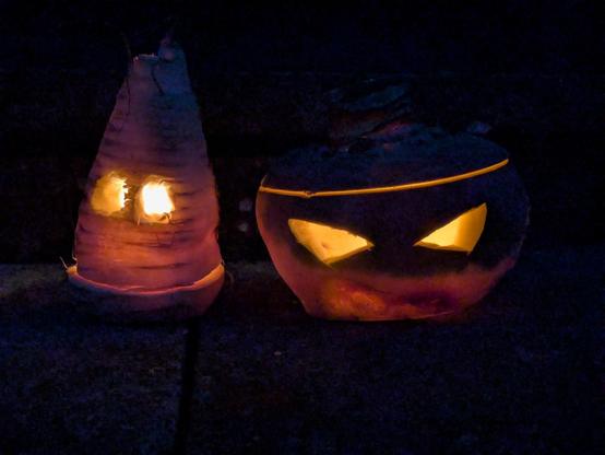 The parsnip and turnip lanterns from the previous post have been lit. Thereās tea light candle burning in each, making the hollowed out vegetables glow. Their eyes are the brightest part of an otherwise very dark image, because theyāre sitting on the door step.