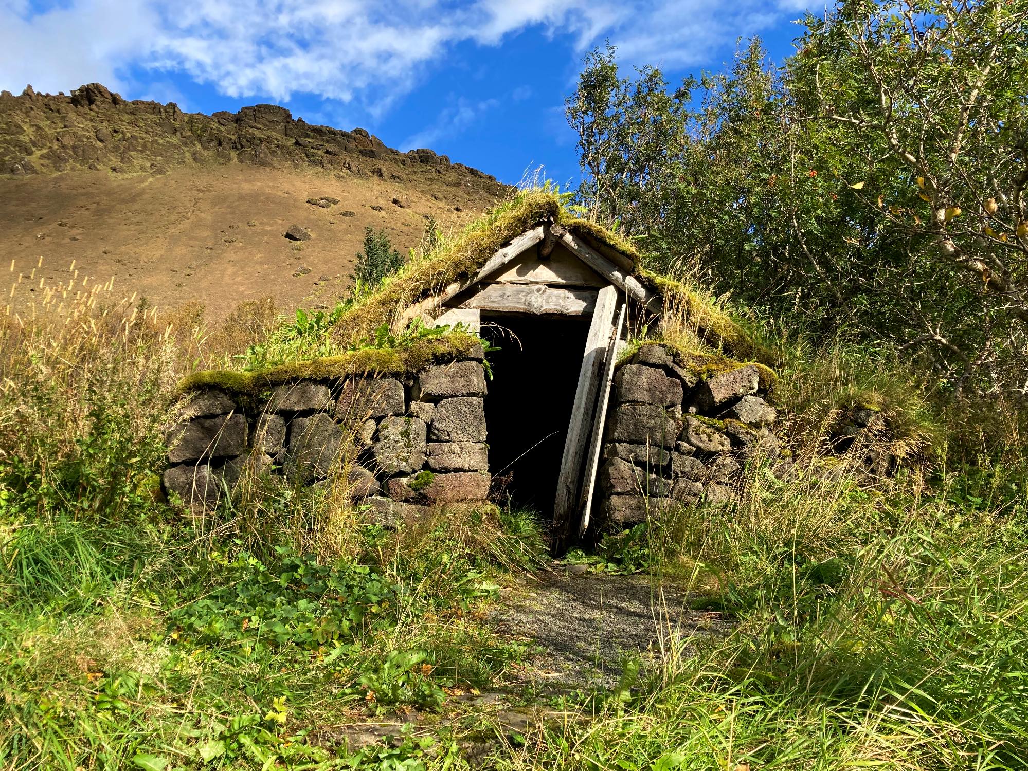A small decrepit turf house.