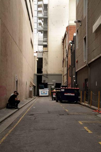 dumpsters in a narrow alley