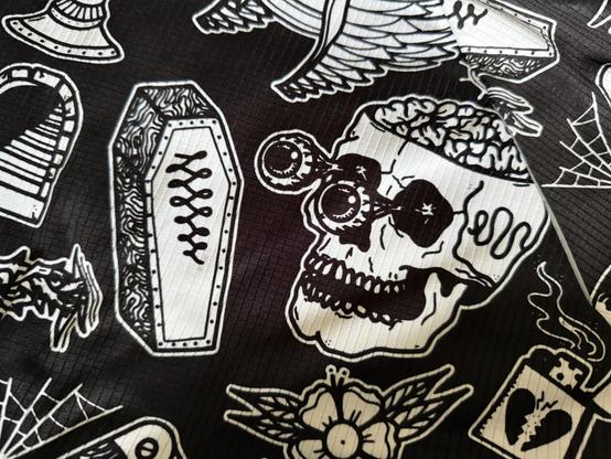 Printed fabric with skull and coffin