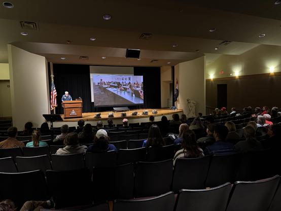 An auditorium full of interns and their families awaiting graduation
