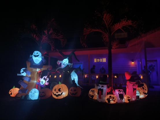 Many inflatable Halloween decorations in front of a house