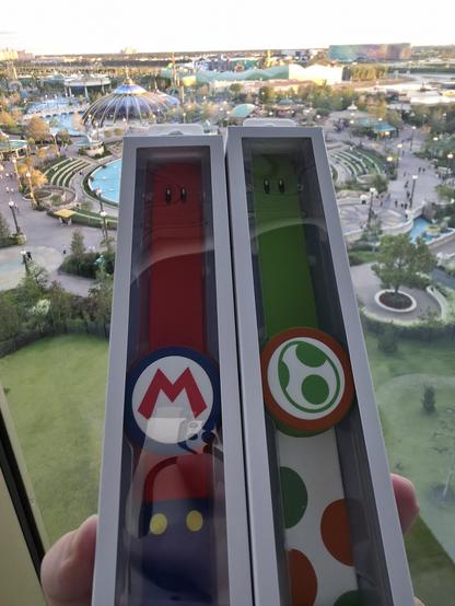 Picture of Mario and Yoshi Power Up Bands standing in front Epic Universe