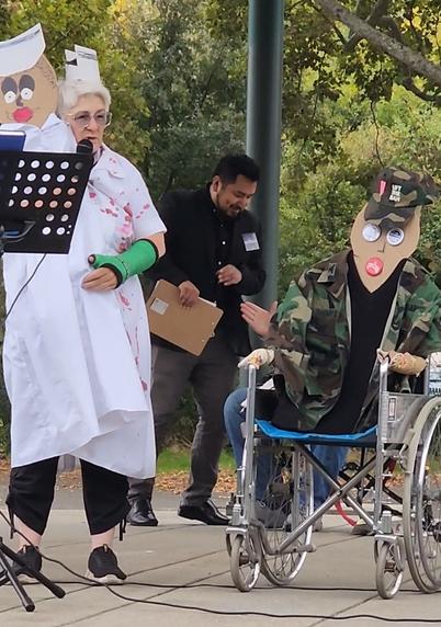 Barbara Brass, one of our local celebrities, talking on stage at the "Democracy Dies in Silence Procession" event on October 25th, 2025.