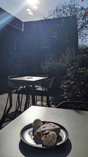 hot apple pie on a outdoor metallic table with sun reflection on the table
