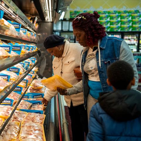Angela Duncan, left, shops for groceries in Springfield, Mass., on Saturday with her daughter and grandson.