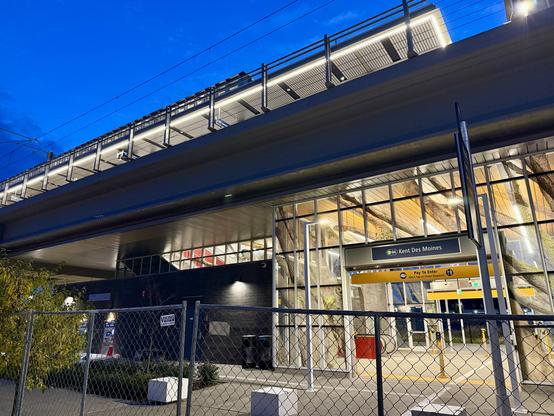 Night view of the Kent Des Moines light rail station looking nearly complete but still fenced off